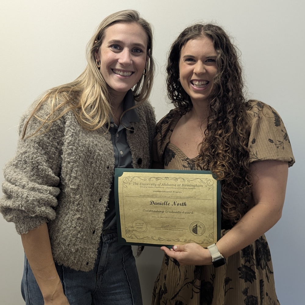Program director Lizzy Davis poses with Danielle North who is holding her award certificate.