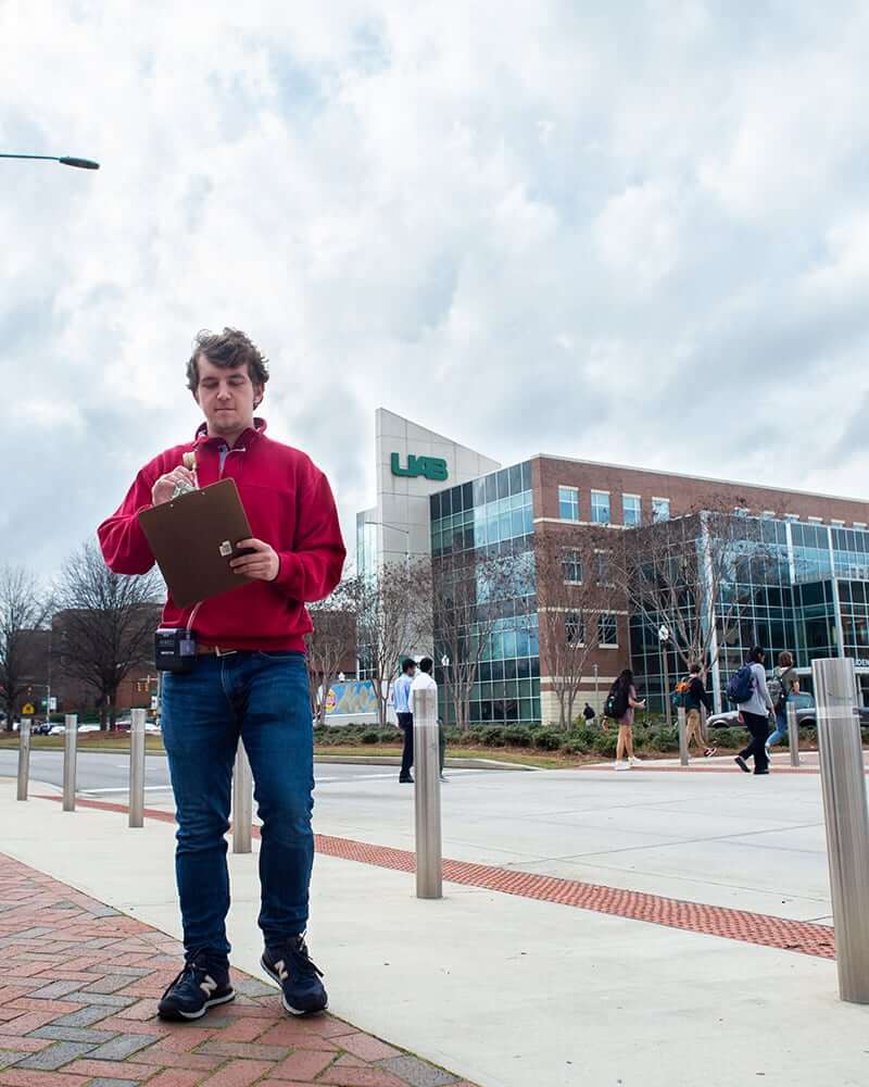 Student conducting research near the UAB Student Center. 