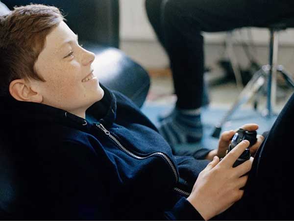  teenage boys playing video games