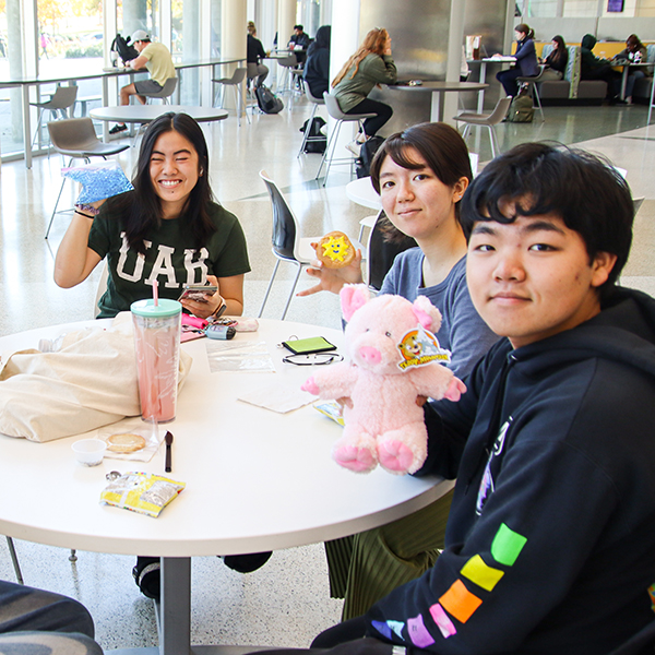 Students holding up their "Study Buddy" plushies for the 2022 DIY day