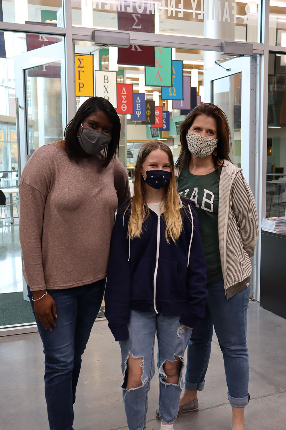 From left to right, Essence Jones, Samantha Walker and Meredith Kahl stand together. Jones and Walker assisted Kahl during the toy distribution for this year's Little Blazer Wishes.
