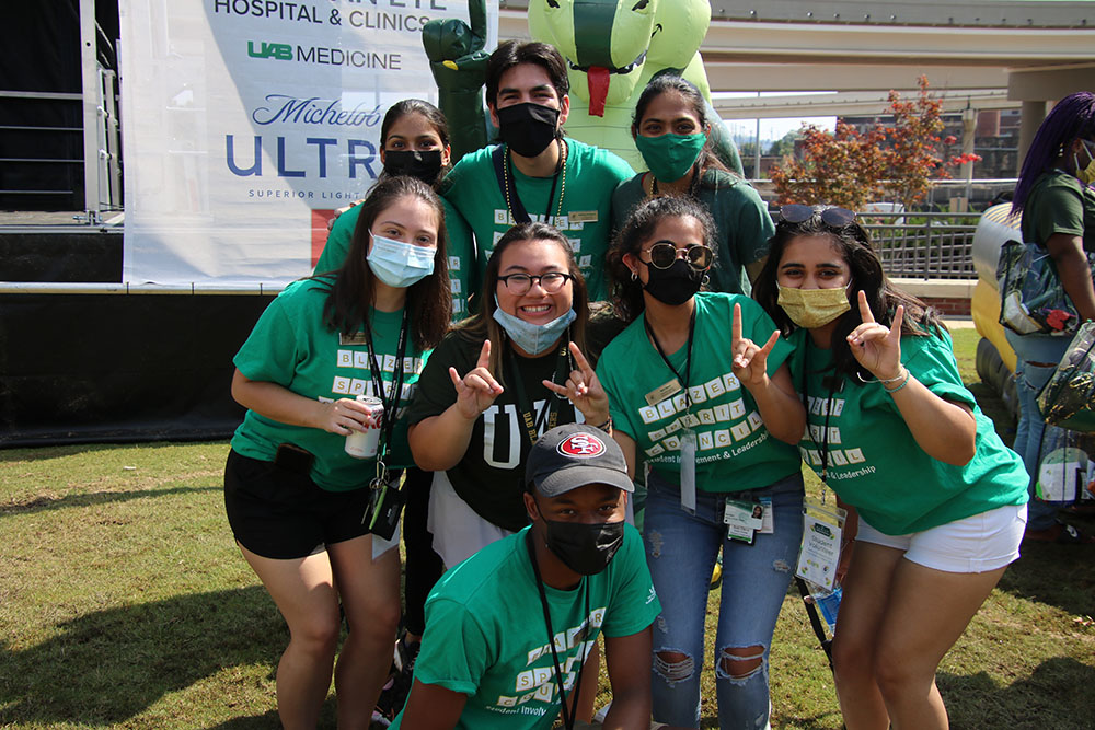 A group of UAB students posing for the camera in front of the inflatable Blaze balloon
