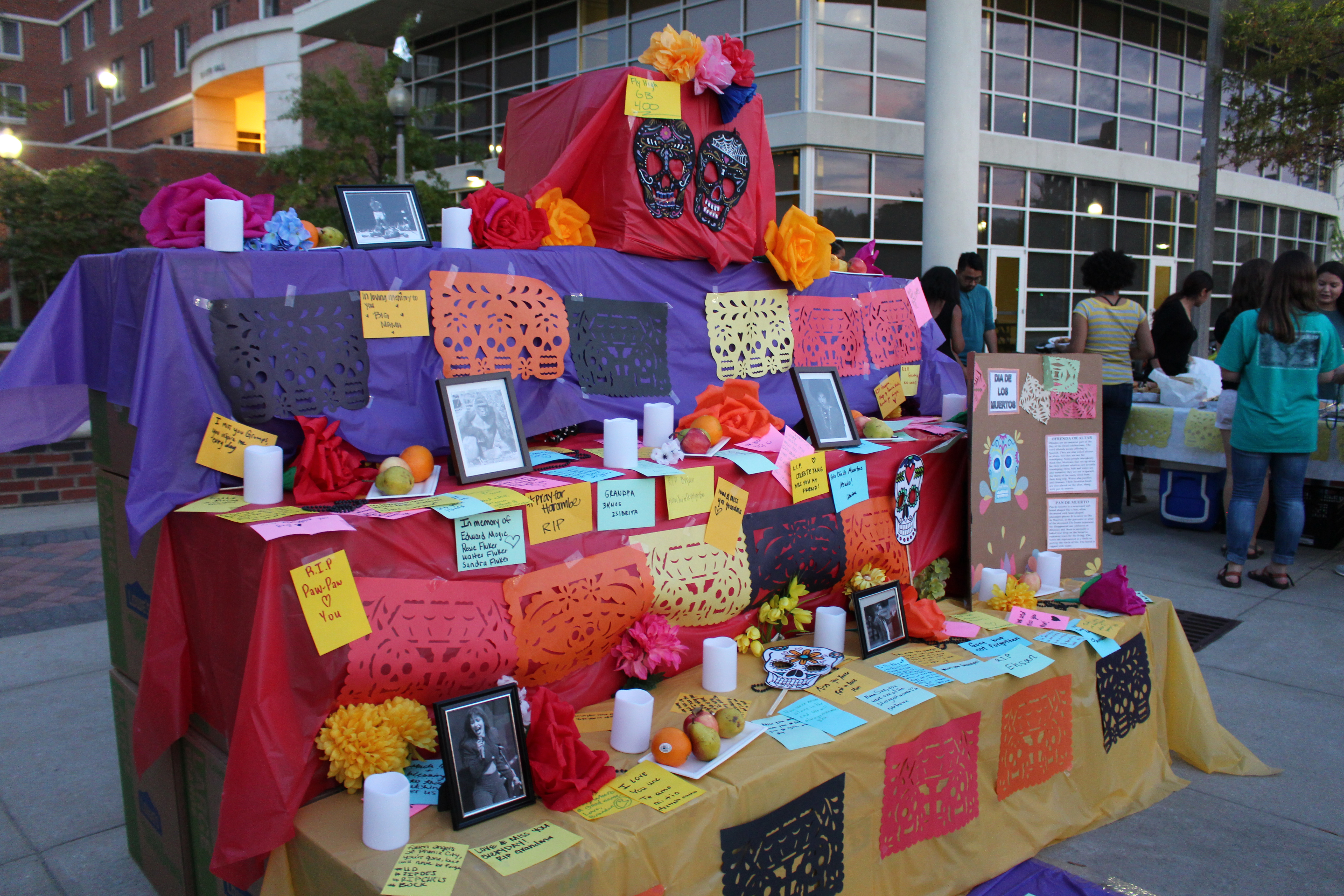 Big photo: SALSA creates a community altar for students to write notes to deceased loved ones with sugar coals and other decorations.  Little photo: Latina culture is displayed at the Commons plaza. Photos by Gerrie Lim