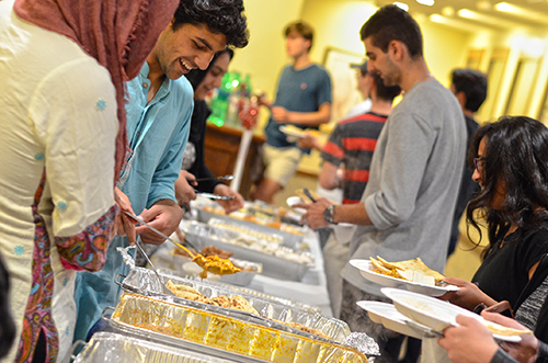 Members of the Muslim Student Association gather in the Green and Gold room at Bartow Arena to serve a meal to Fastathon attendees after a day-long fast. Photo by Ian Keel