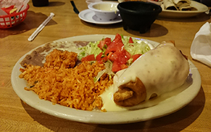 The Los Amigos chimichanga is drenched in queso when it comes to your table. (Photo by Jackson Hyde)