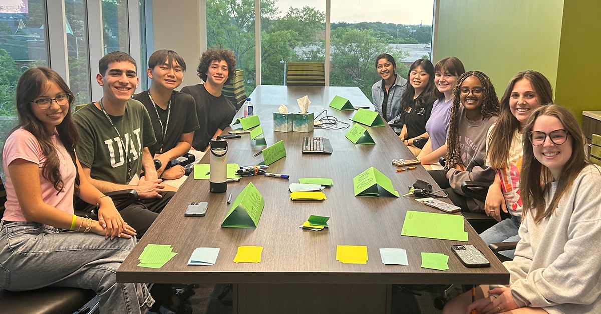 EMSAP Students Around Long Table With Coloful Papers