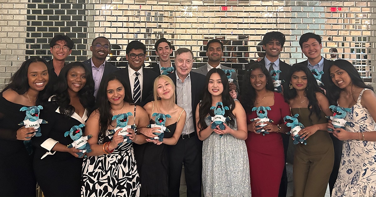 Group of EMSAP students holding blaze dragon plushies