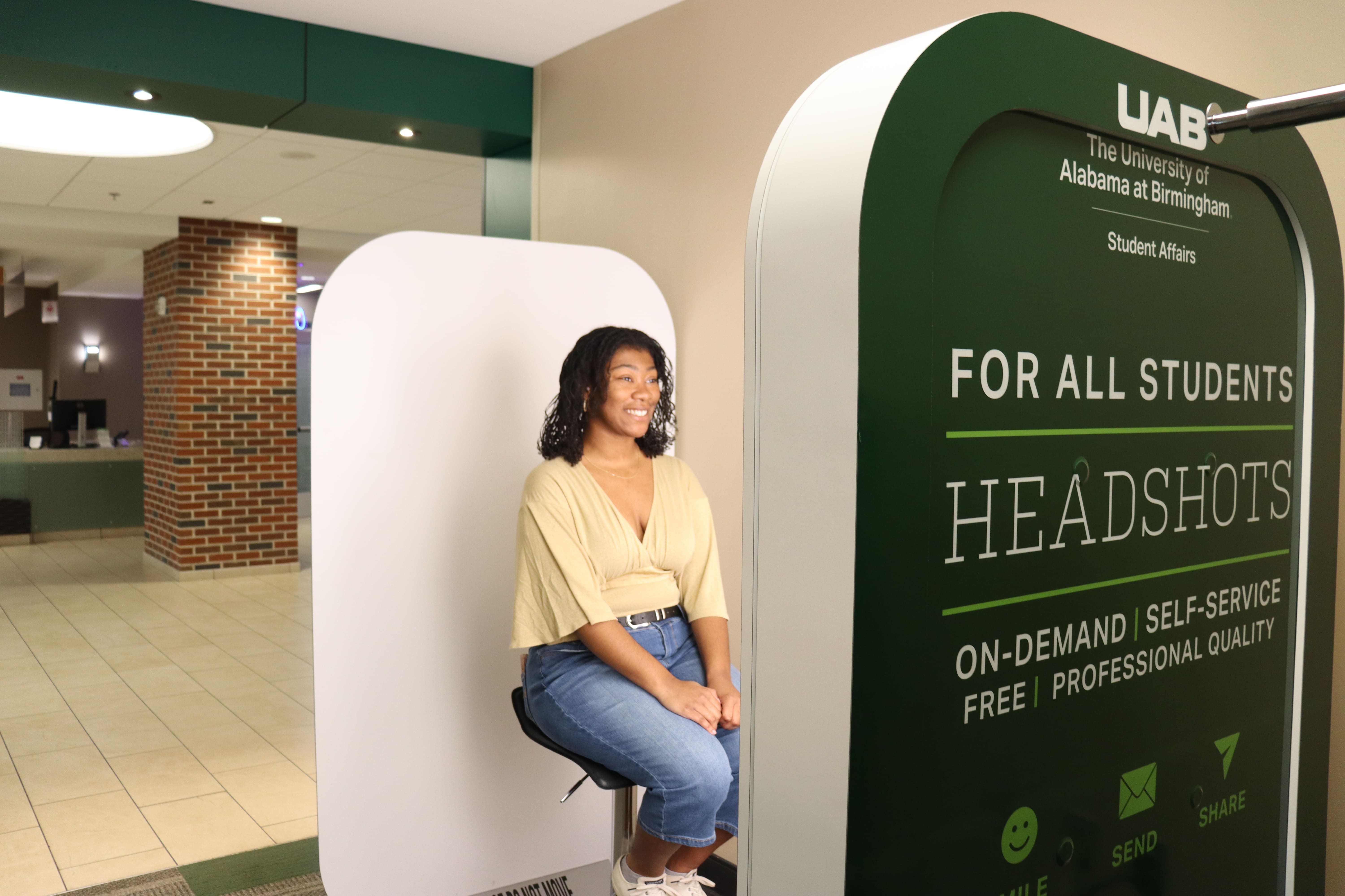 Student taking headshot at Iris Photo Booth