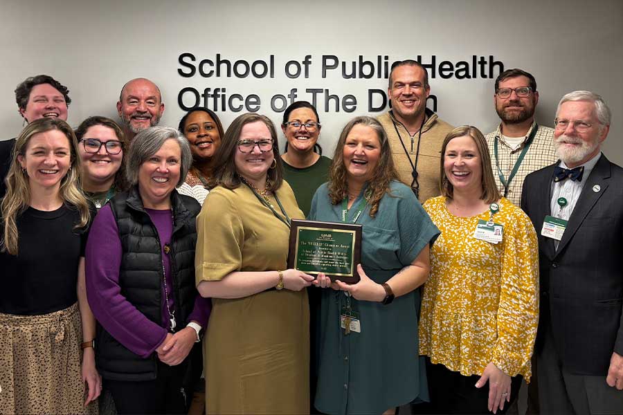 SHP student services team with plaque.
