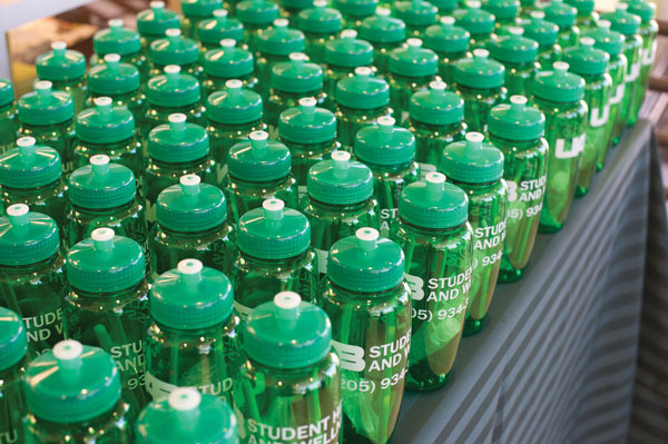 UAB Branded water bottles on a table.