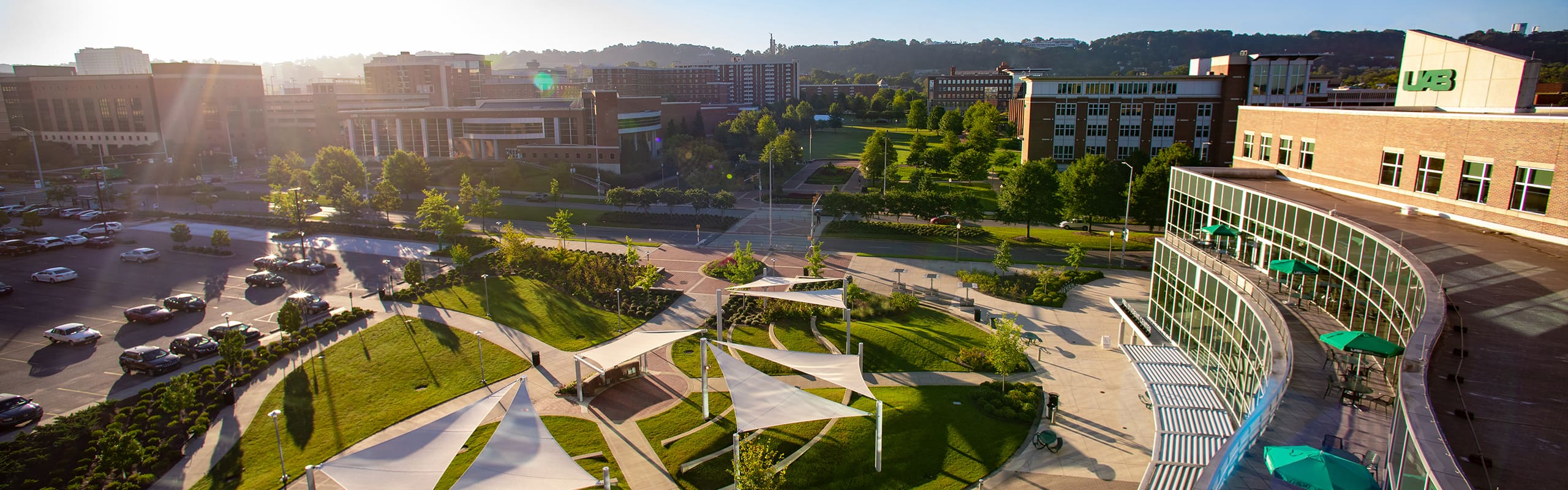 Drone style shot in front of the UAB Hill Student Center showing the amphitheater and the campus green.