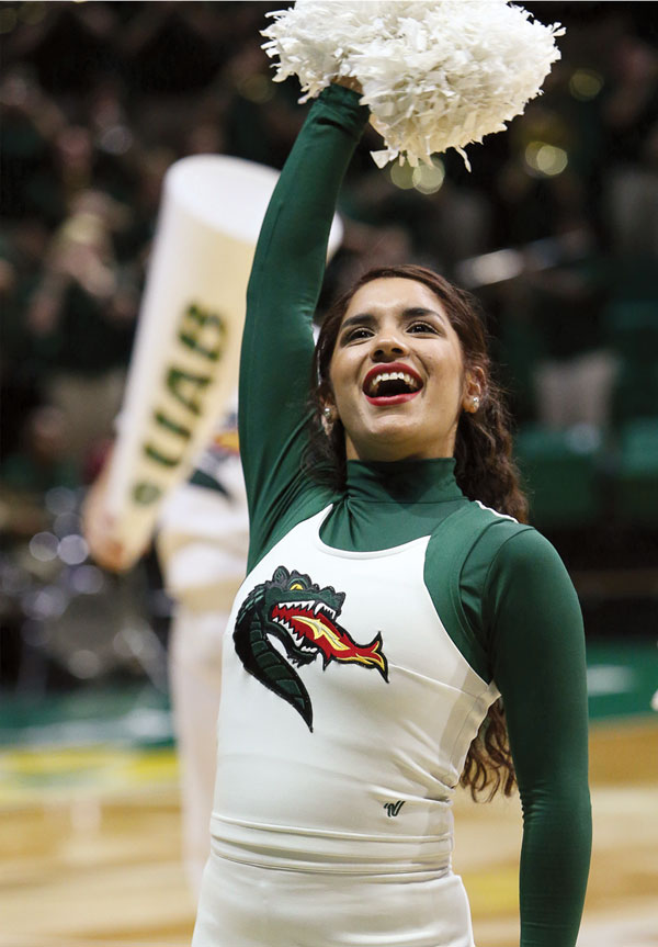 Photo of cheerleader Ashley Garcia cheering at basketball game