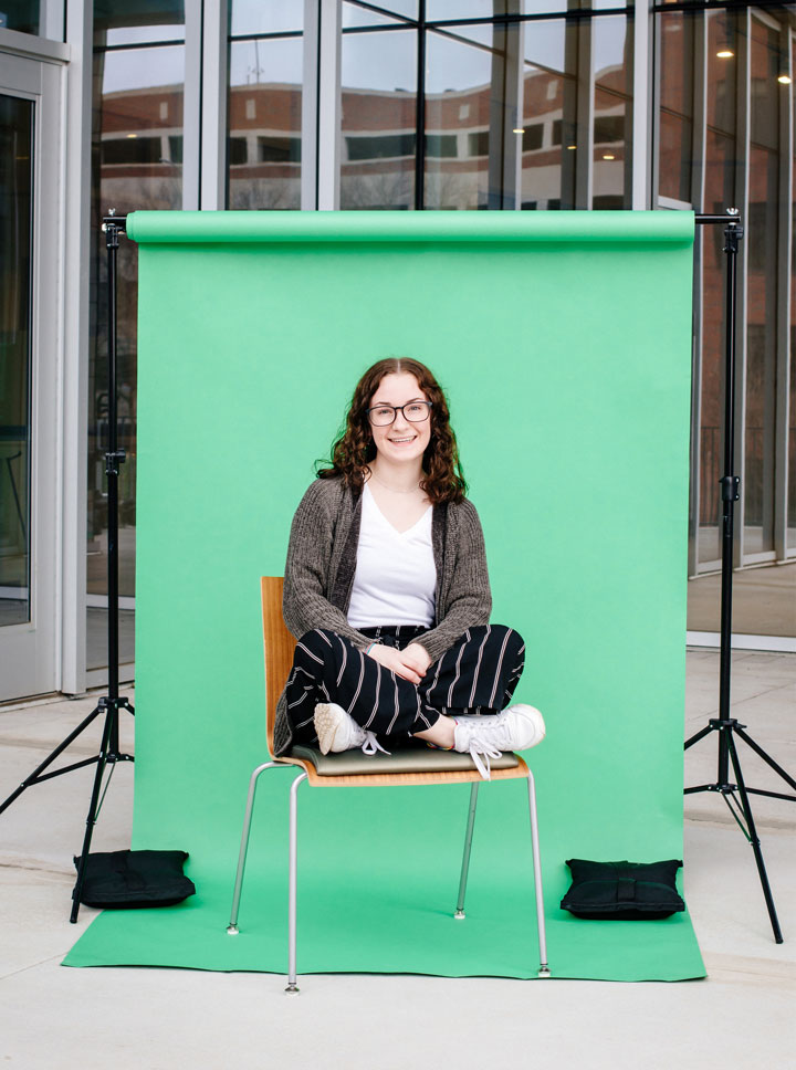 Photo of Lauren Lockhart against green backdrop and photo lights