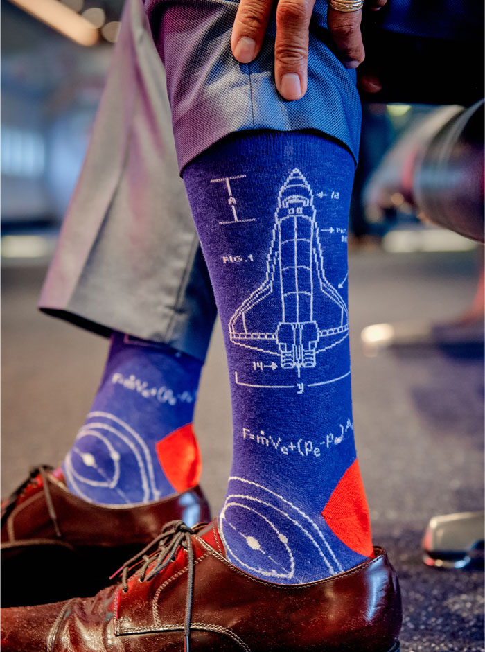 Closeup of August Oo's space shuttle-themed socks