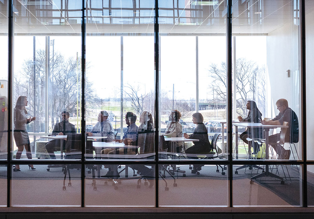 Photo of people meeting in a glass-walled room in the Bill L. Harbert Institute for Innovation and Entrepreneurship