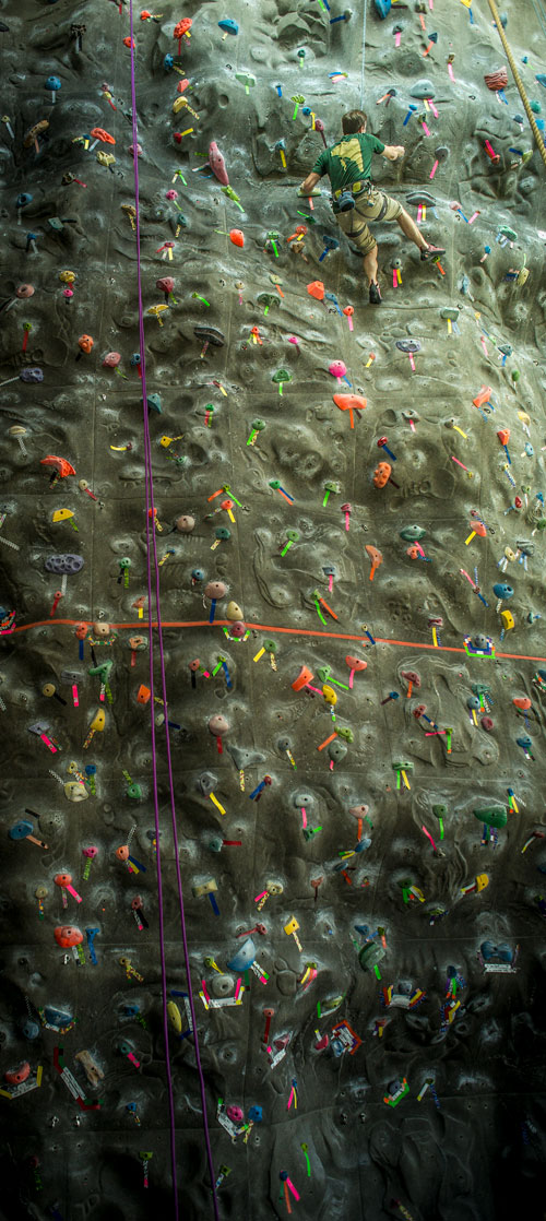 Photo of student near top of climbing wall