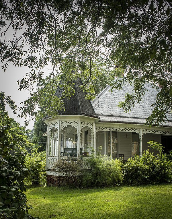 Photo of Greensboro front porch surrounded by greenery