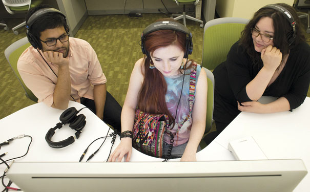 Photo of Shibli Rahman, Samantha Richardson, and Jeanette Vasquez with headphones and computers