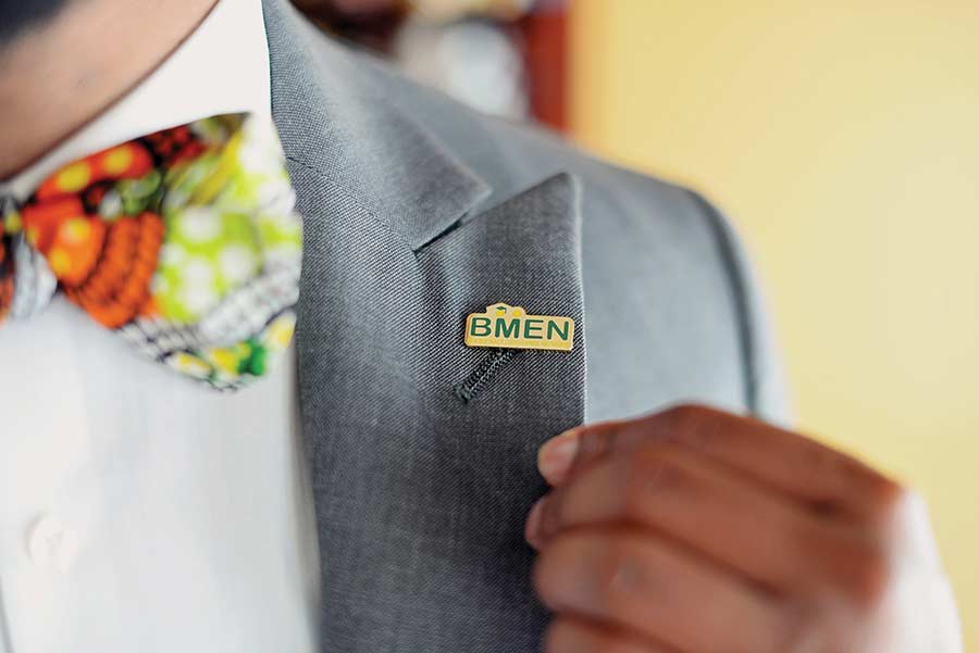 Closeup photo of BMEN pin on suit jacket lapel
