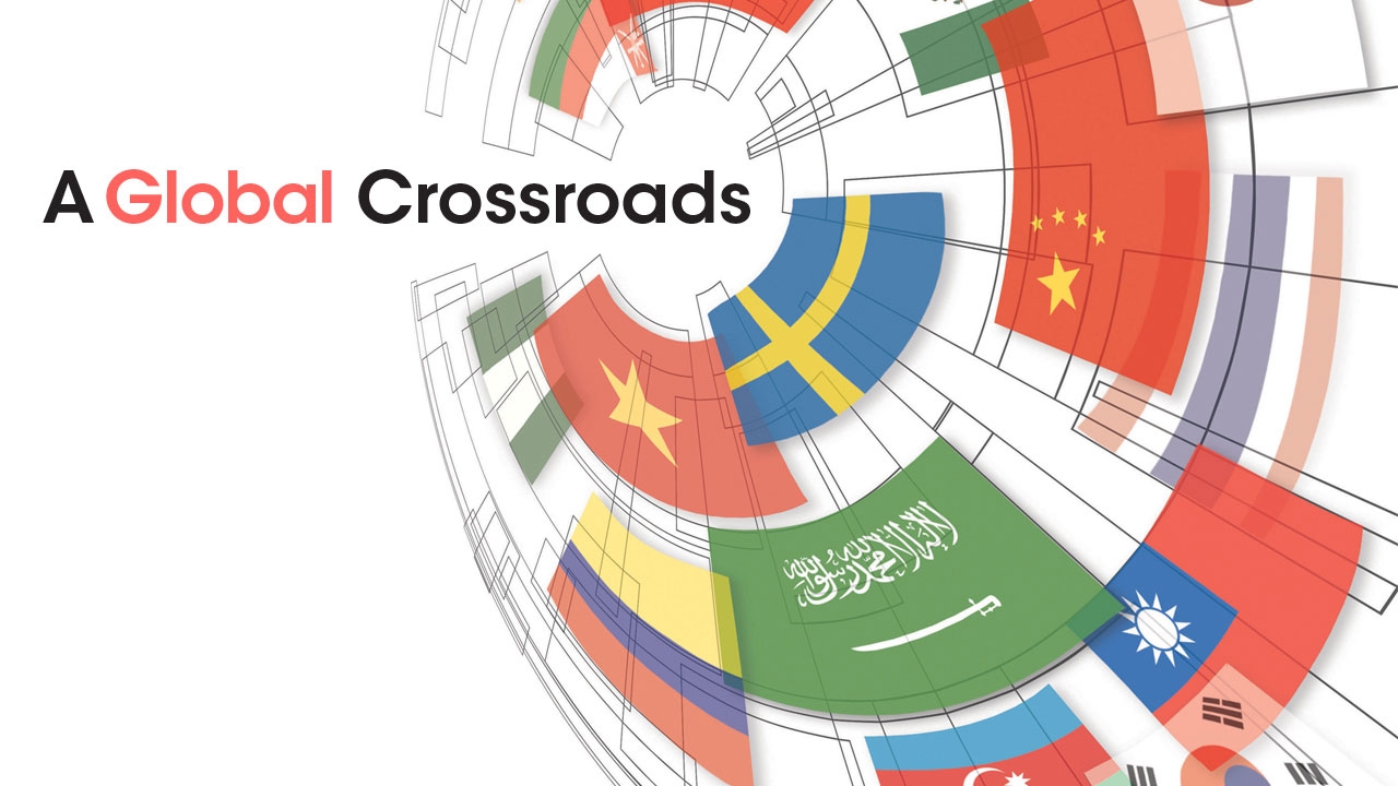 Illustration showing globe of international flags; headline: A Global Crossroads