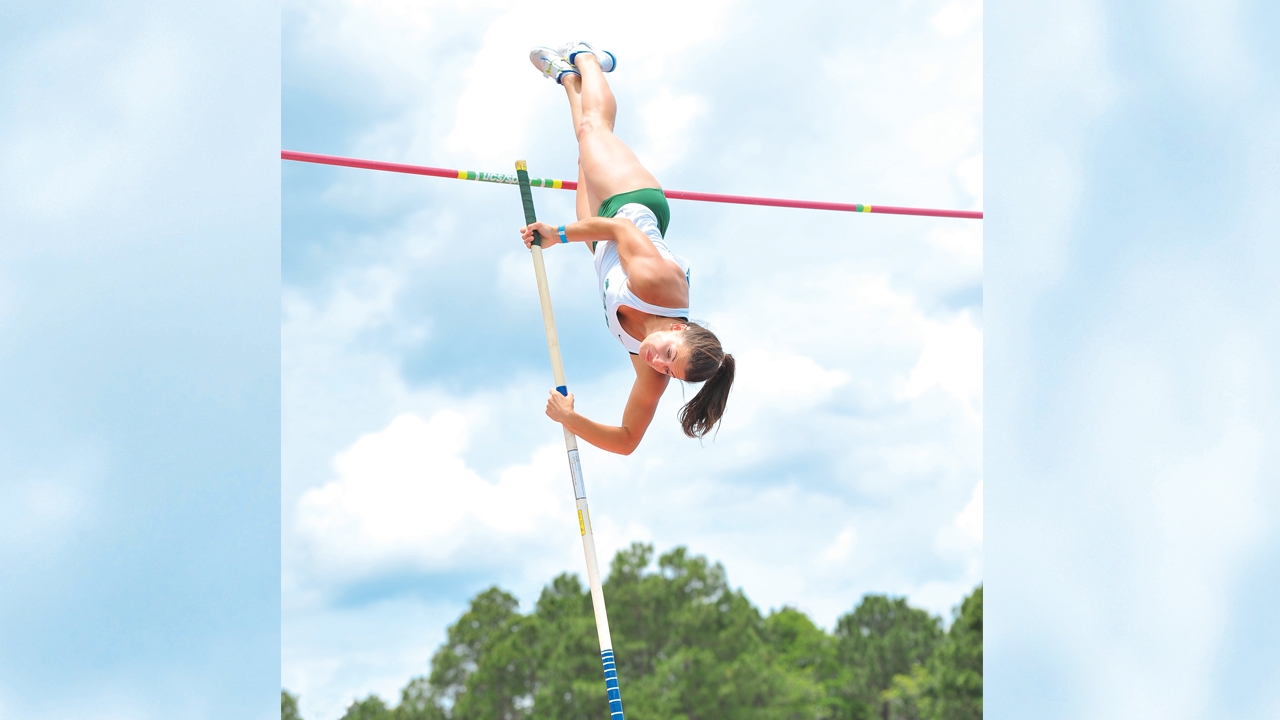 Photo of student Neal Tisher pole vaulting