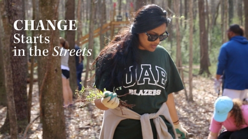 Photo of UAB student volunteering at Red Mountain Park; headline: Change Starts in the Streets