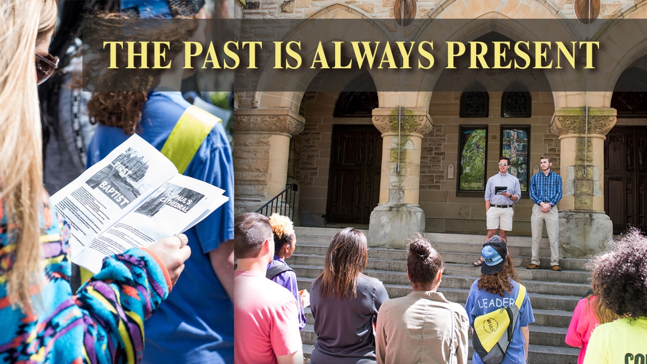 Photo of students on walking tour in front of downtown church. Title: The Past Is Always Present