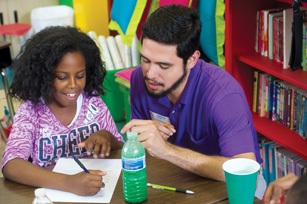 UABTeach student tutoring elementary student.