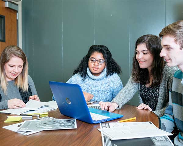 Students in a workshop session with a Writing Center tutor
